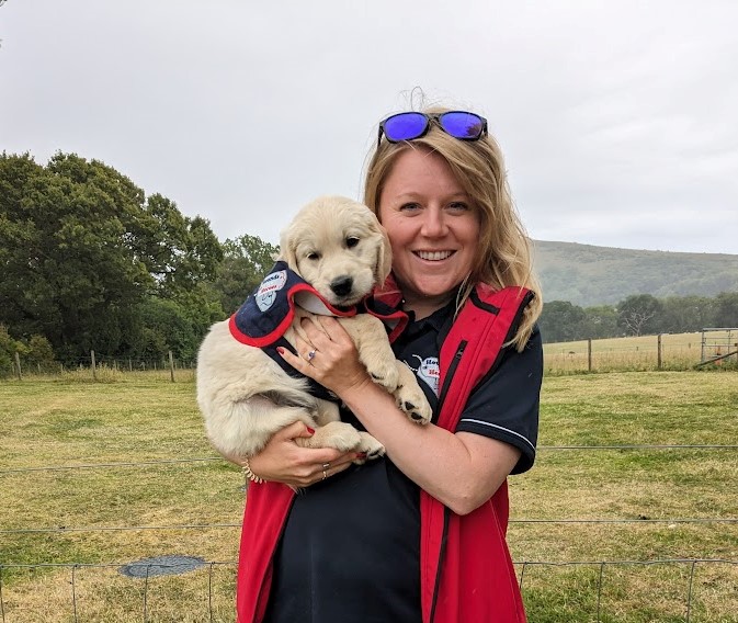 Lady holding a puppy.